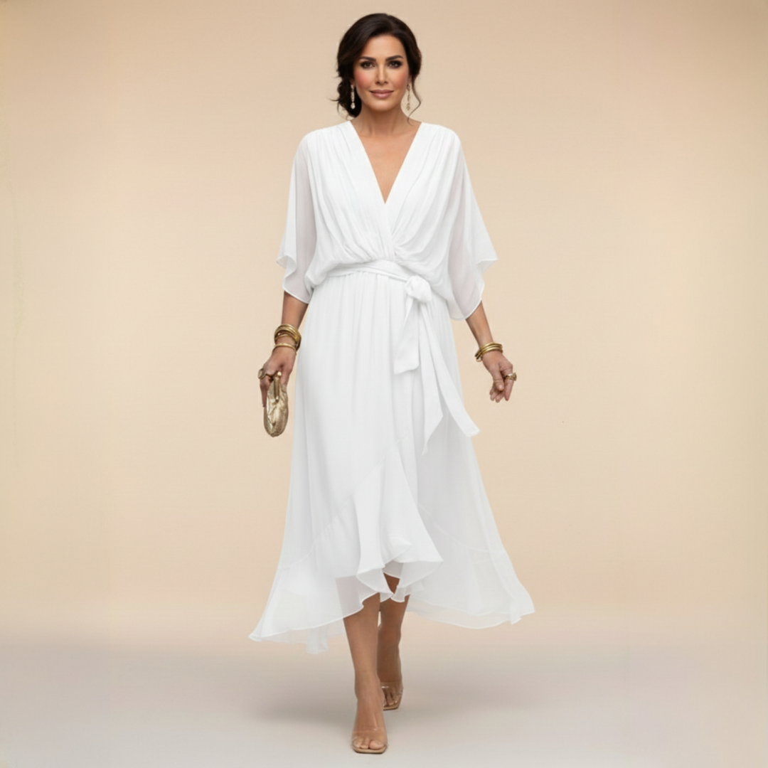 Woman wearing flowing V-neck dress in studio setting