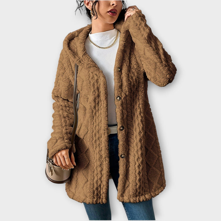 Woman wearing textured hooded winter jacket in relaxed fit