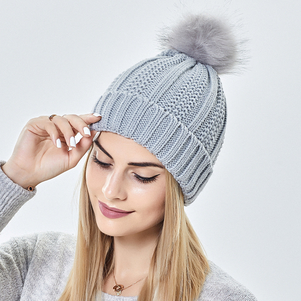 Women's satin lined knit beanie with pom pom