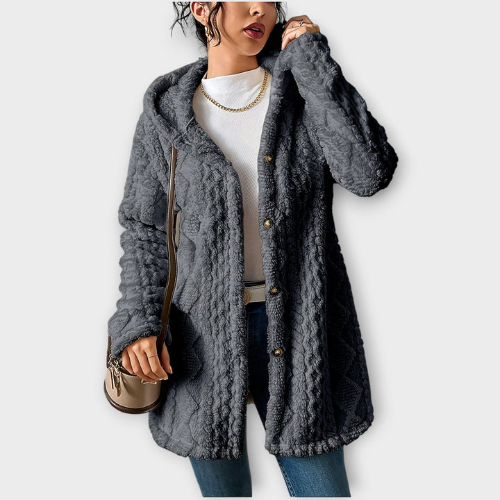 Woman wearing textured hooded winter jacket in relaxed fit