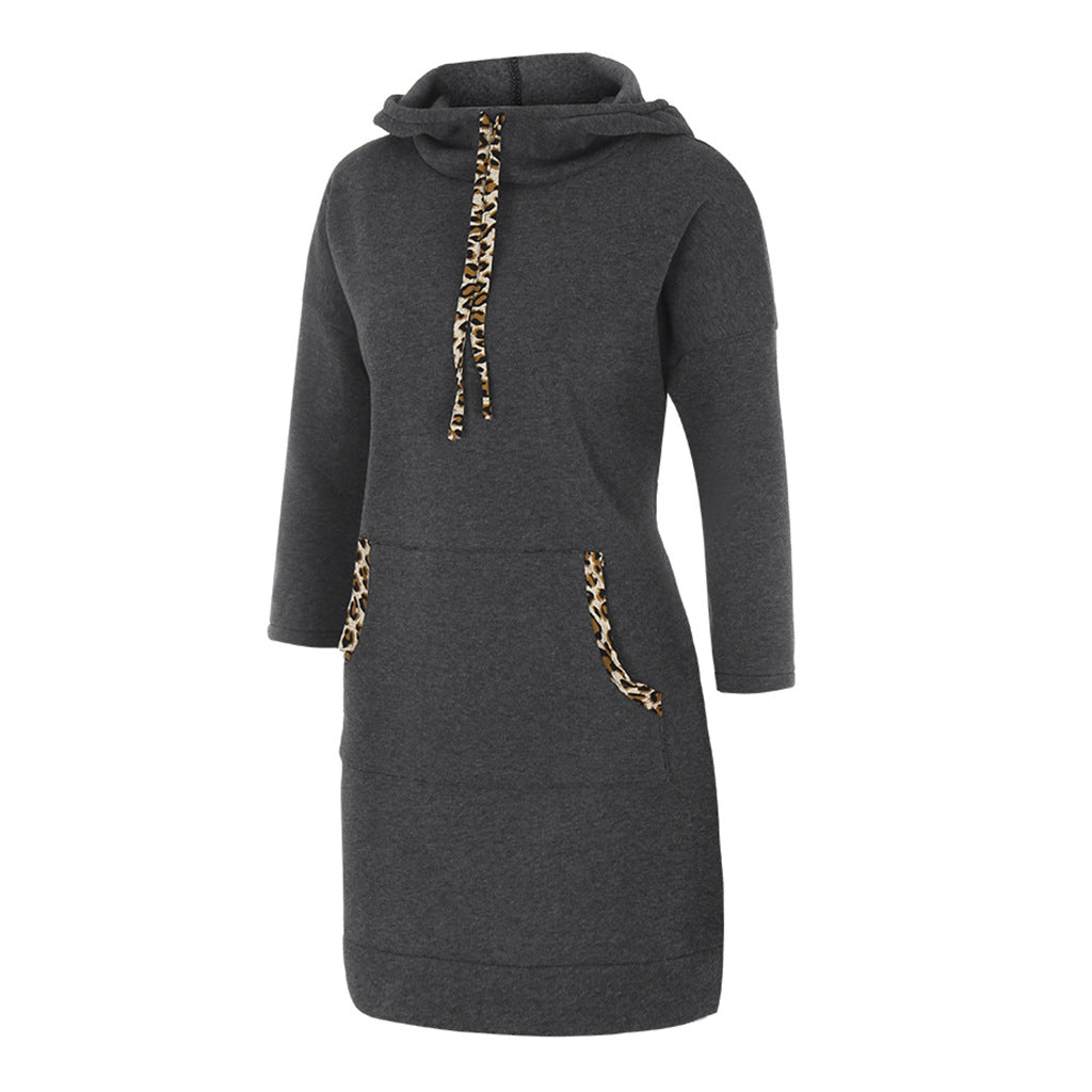 Woman wearing hooded sweatshirt dress with leopard-print drawstrings