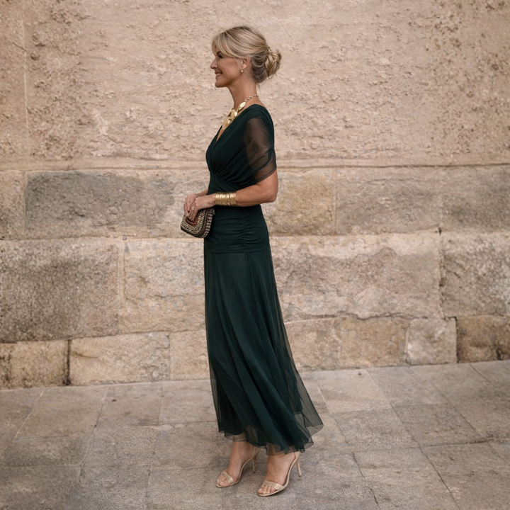 Woman wearing flowing maxi dress with crossover V-neck