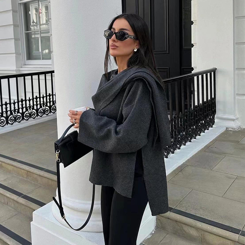 Woman wearing knit cardigan coat with asymmetric scarf detail