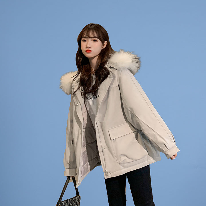 Woman wearing loose hooded winter coat in neutral tones