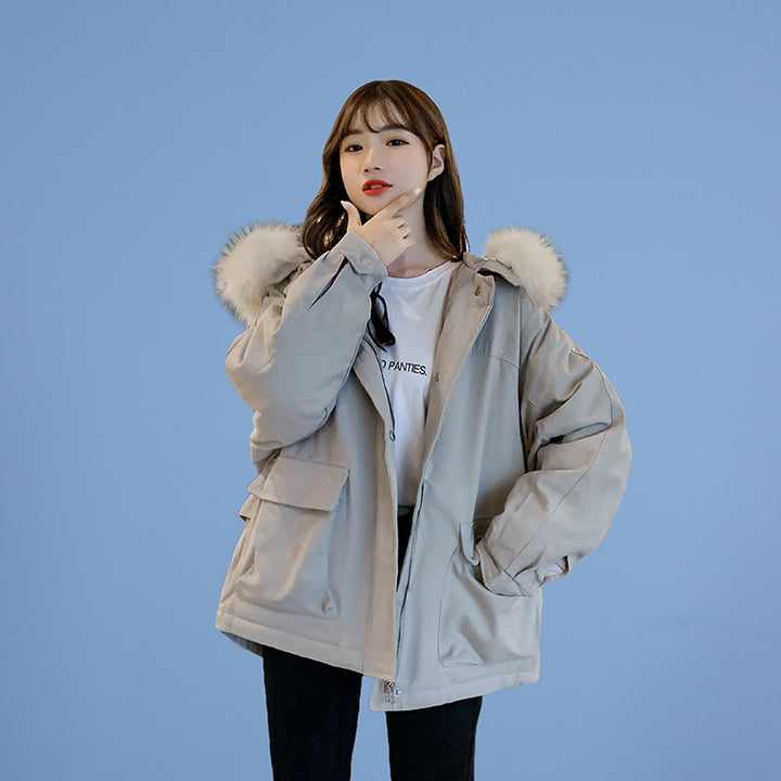 Woman wearing loose hooded winter coat in neutral tones