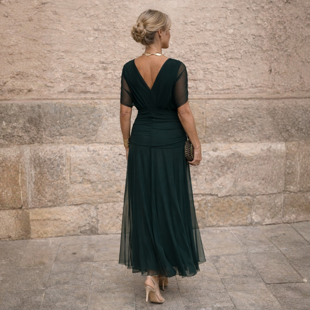 Woman wearing flowing maxi dress with crossover V-neck