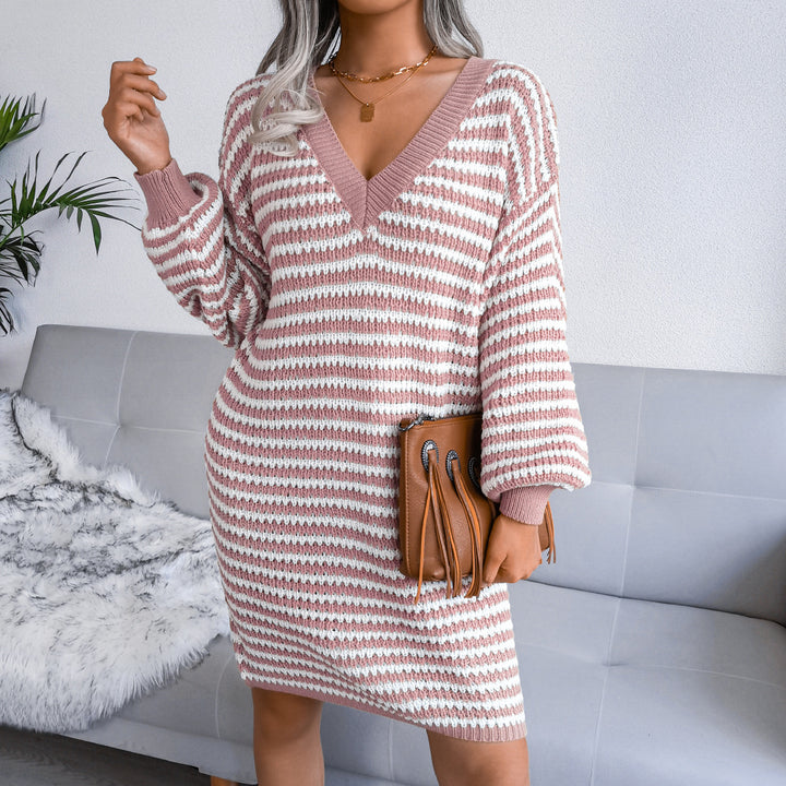 Woman wearing striped V-neck sweater dress with lantern sleeves