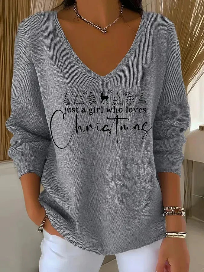 Woman wearing V-neck Christmas sweater with festive print