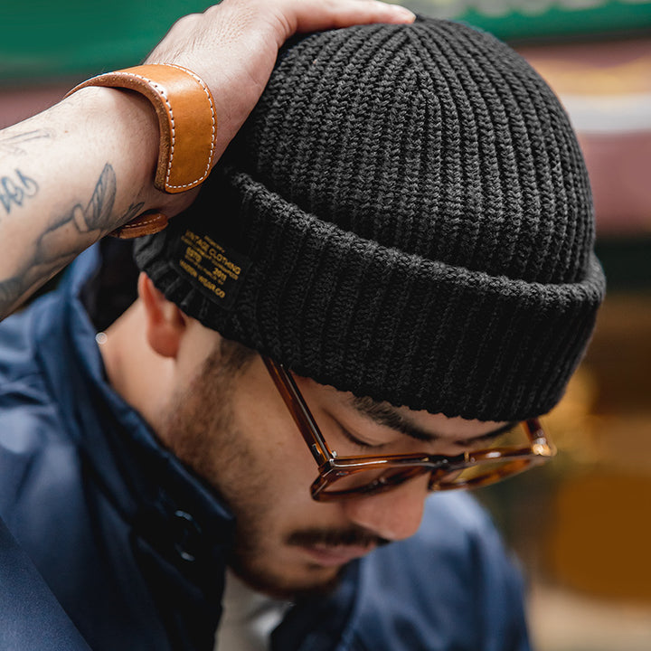 Black knitted beanie with street style patch detail
