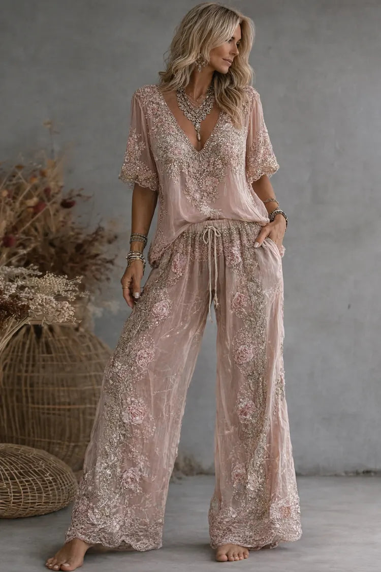 Woman wearing floral embroidered V-neck top and wide leg pants