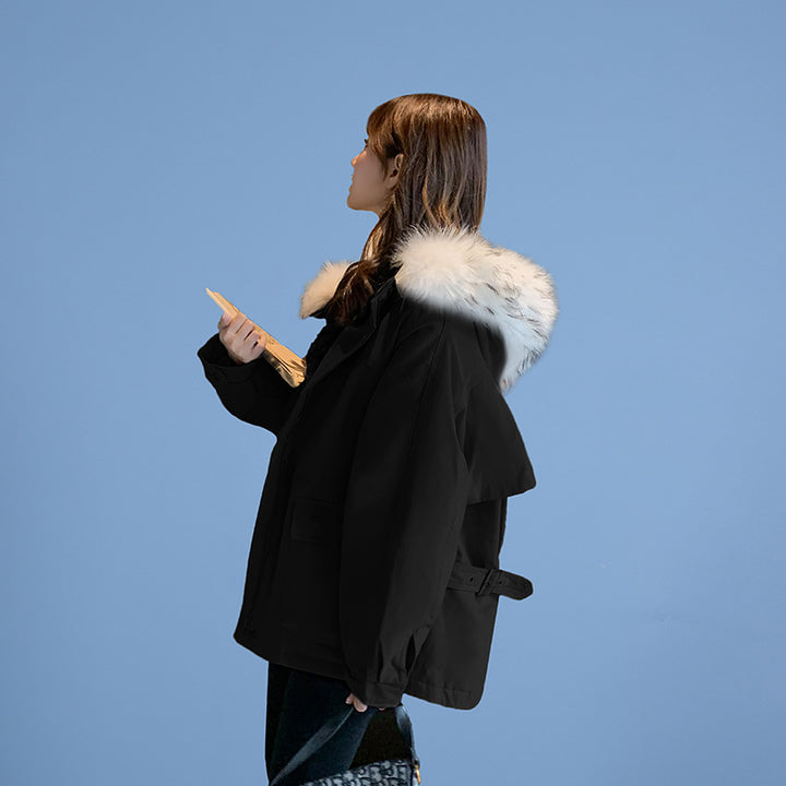 Woman wearing loose hooded winter coat in neutral tones
