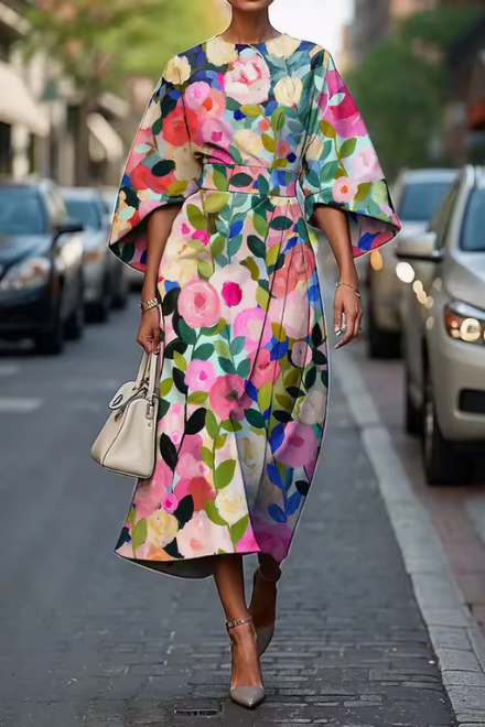 Woman wearing pink and green floral dress with flowing skirt