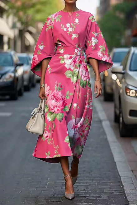 Woman wearing pink and green floral dress with flowing skirt