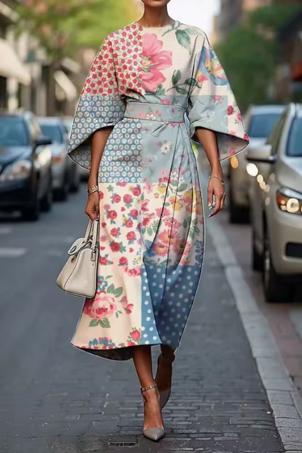 Woman wearing pink and green floral dress with flowing skirt