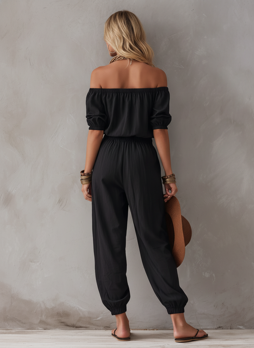 Woman wearing black off-shoulder sleeveless jumpsuit outdoors