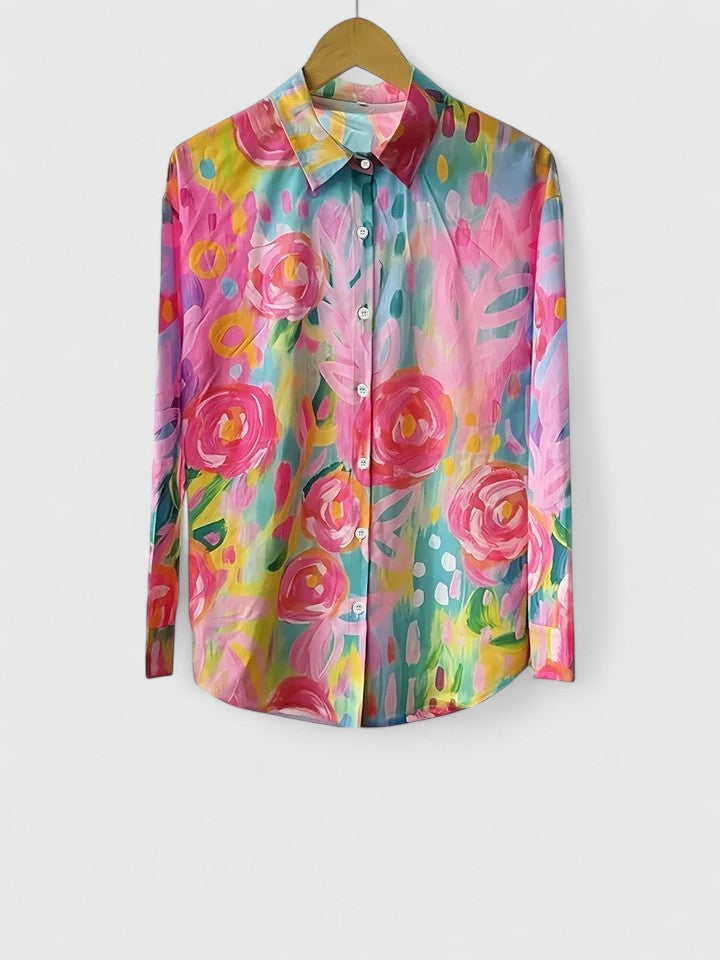 Woman wearing printed button up blouse with artistic prints