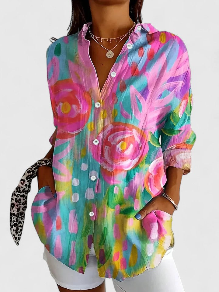 Woman wearing printed button up blouse with artistic prints