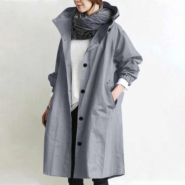 Woman wearing long hooded button-front coat outdoors