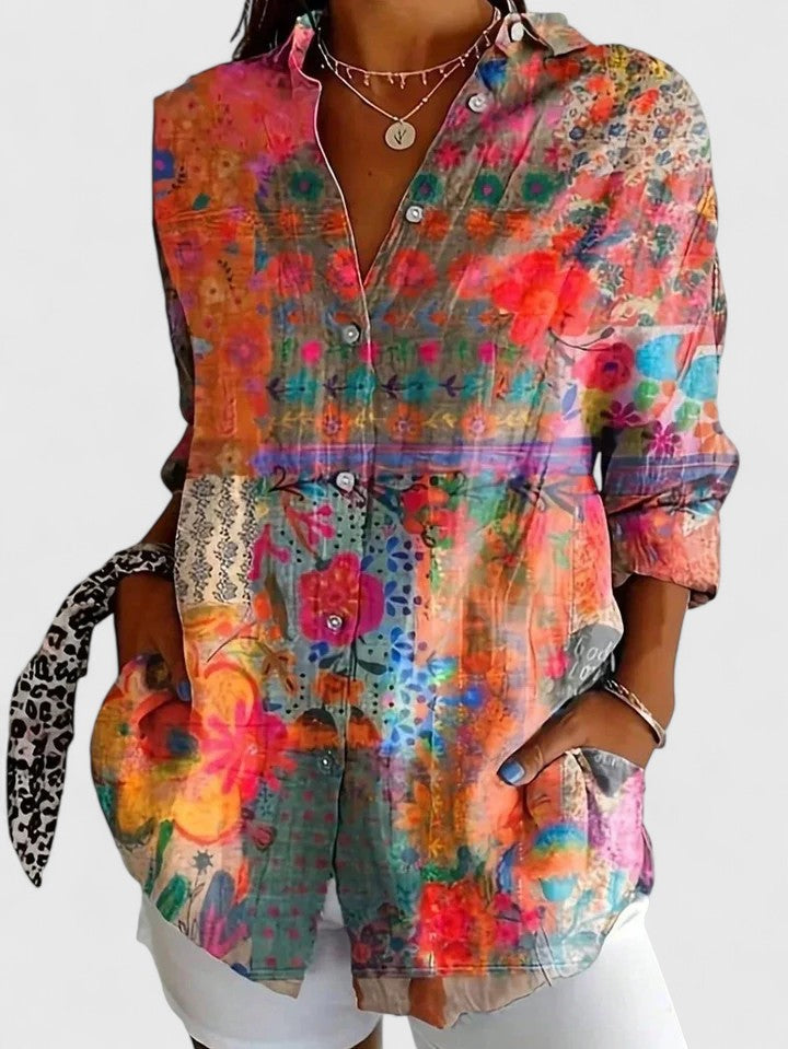 Woman wearing printed button up blouse with artistic prints