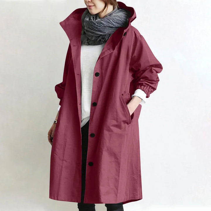 Woman wearing long hooded button-front coat outdoors