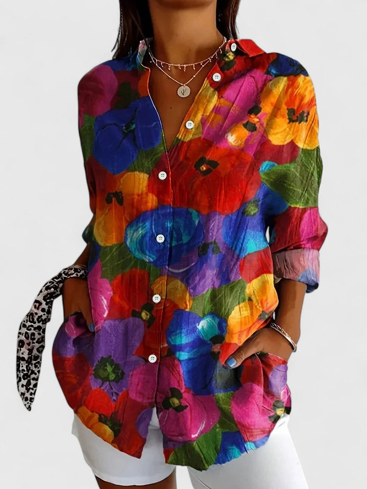 Woman wearing printed button up blouse with artistic prints