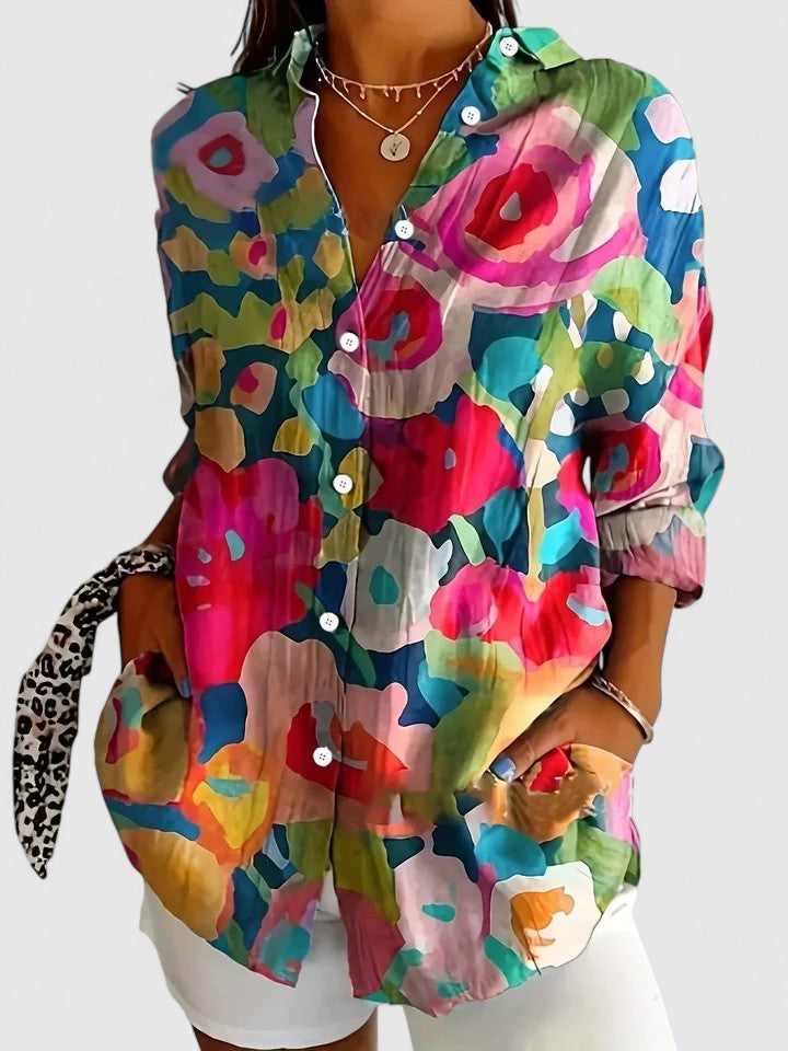 Woman wearing printed button up blouse with artistic prints