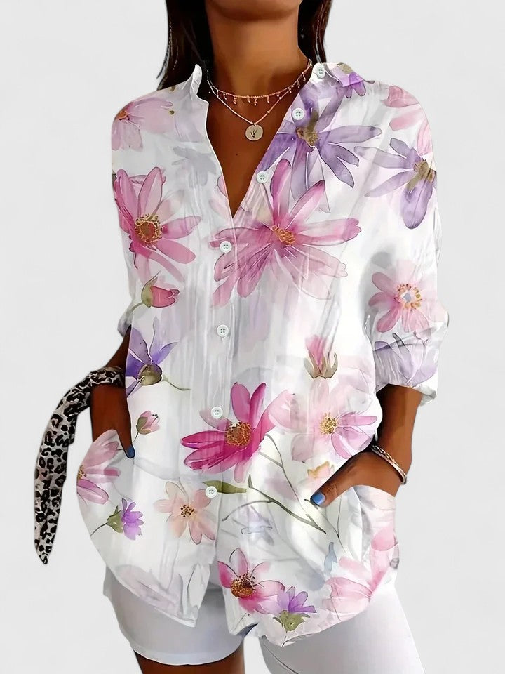 Woman wearing printed button up blouse with artistic prints