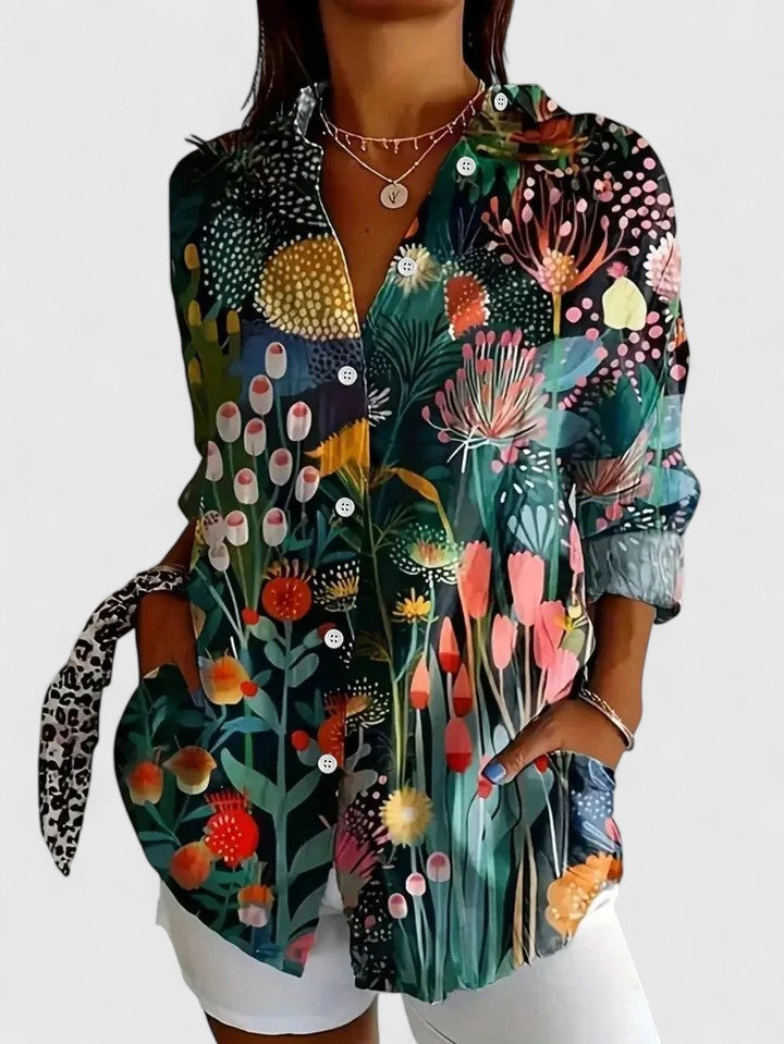 Woman wearing printed button up blouse with artistic prints