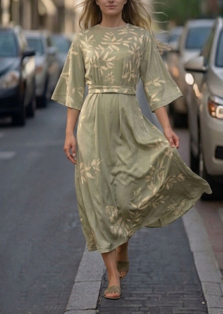 Woman wearing pink and green floral dress with flowing skirt
