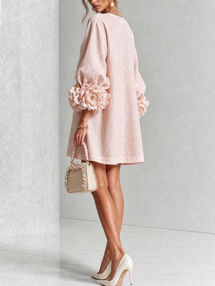 Pink floral mini dress with long sleeves and rosette cuffs