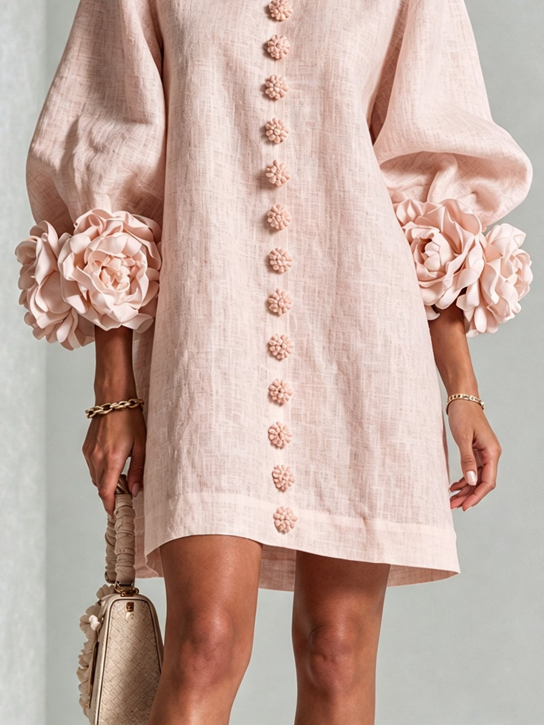 Pink floral mini dress with long sleeves and rosette cuffs