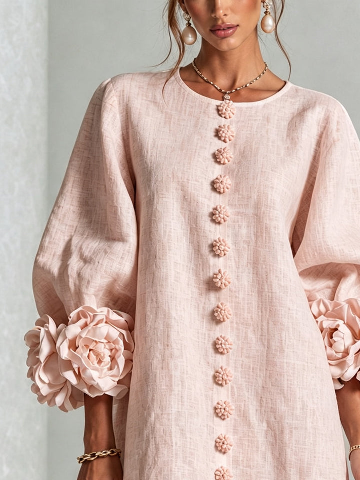 Pink floral mini dress with long sleeves and rosette cuffs