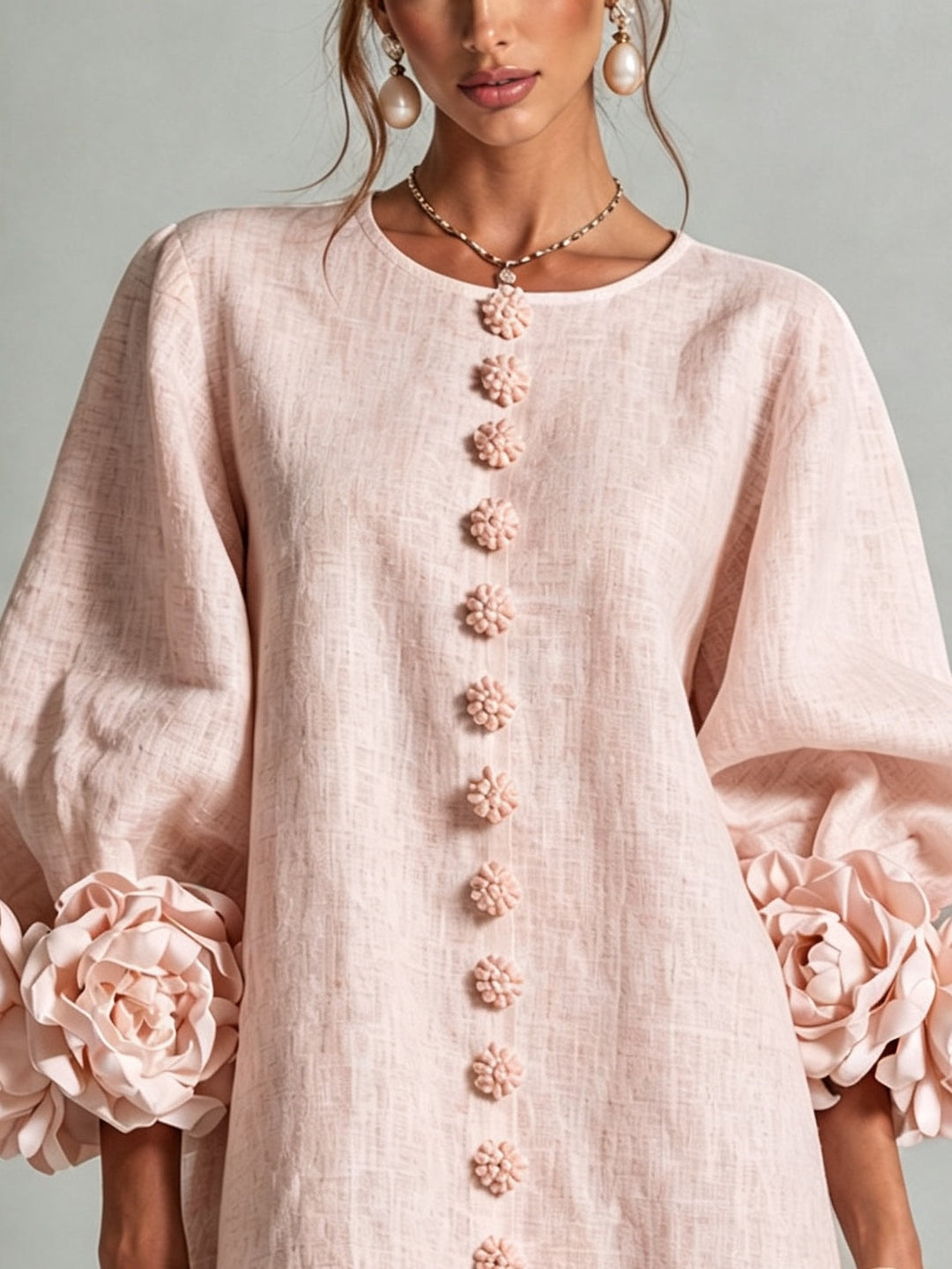 Pink floral mini dress with long sleeves and rosette cuffs