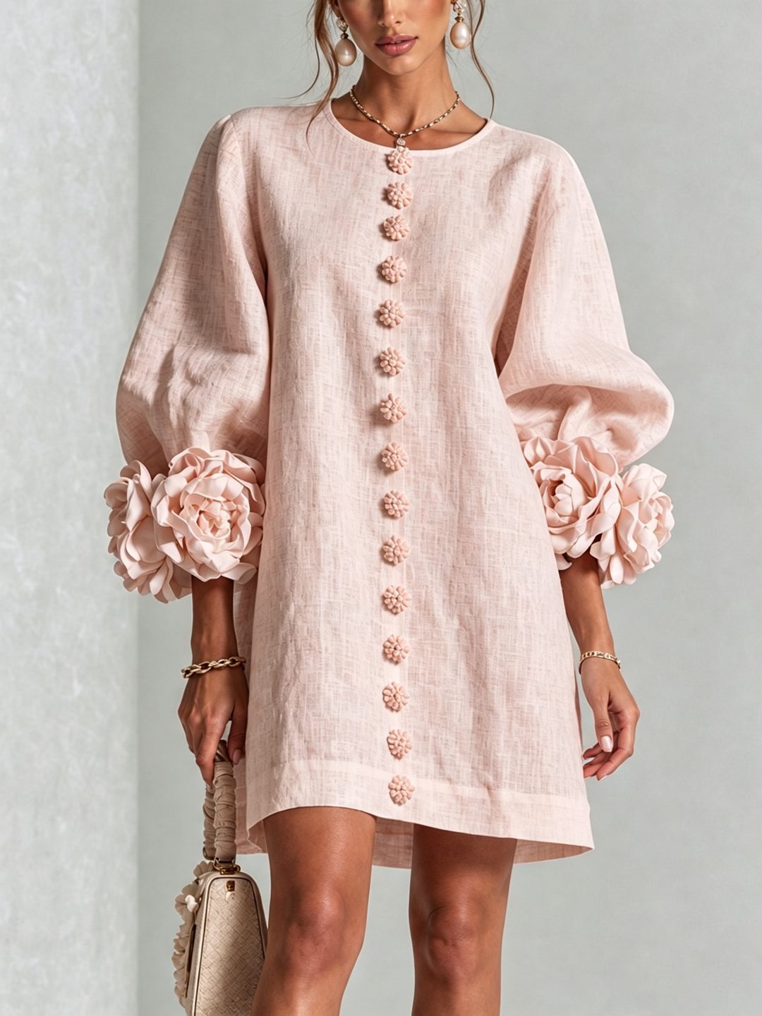 Pink floral mini dress with long sleeves and rosette cuffs