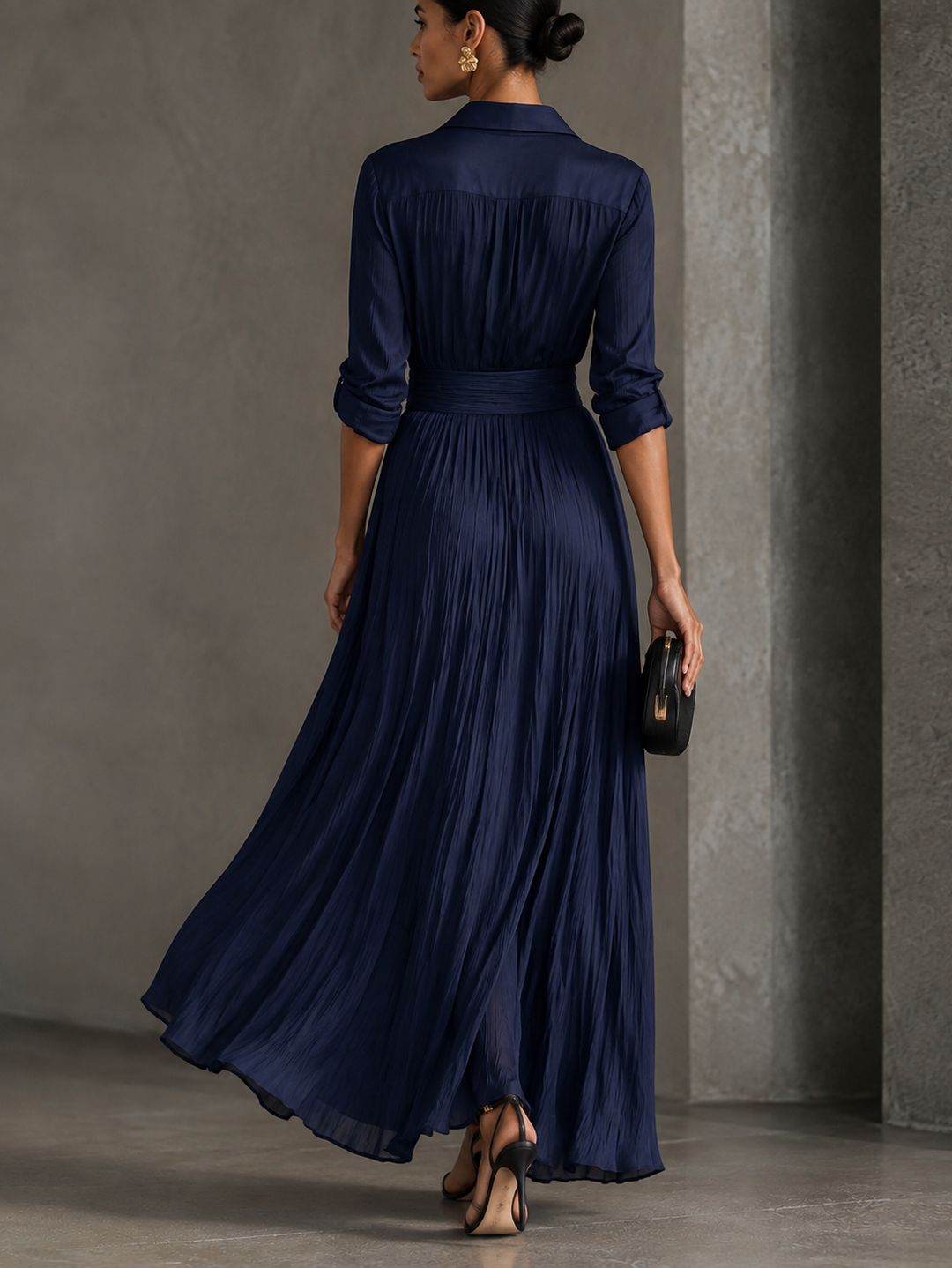Woman wearing navy V-neck maxi shirt dress with knotted waist