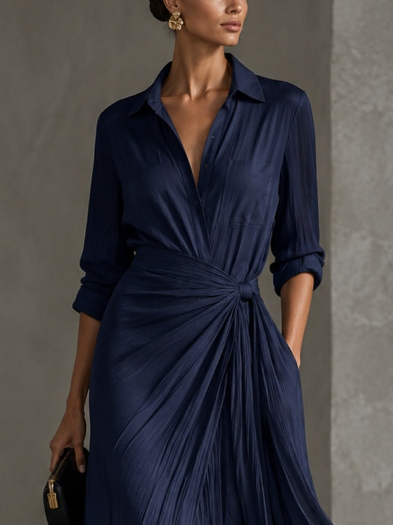 Woman wearing navy V-neck maxi shirt dress with knotted waist