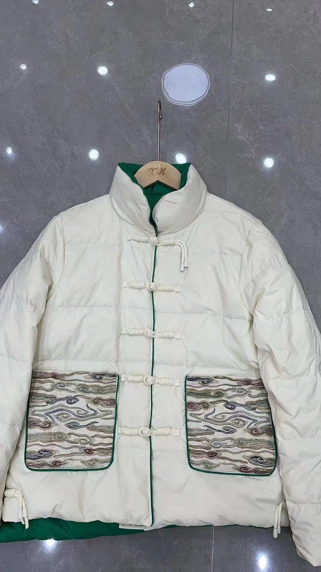 Woman wearing short embroidered down jacket with long sleeves