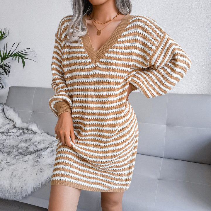 Woman wearing striped V-neck sweater dress with lantern sleeves