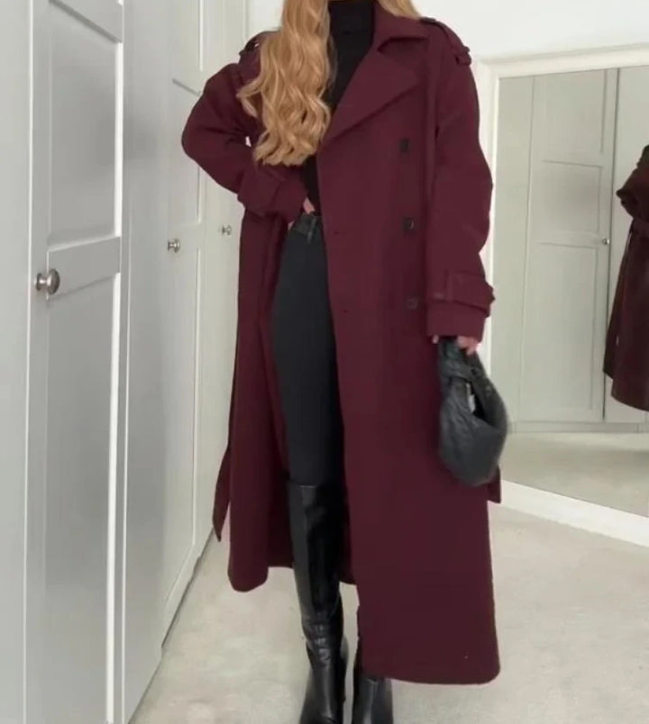 Woman wearing wine red long double-breasted trench coat with belt