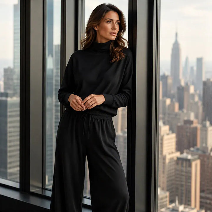 Woman wearing black turtleneck two-piece set with wide-leg trousers