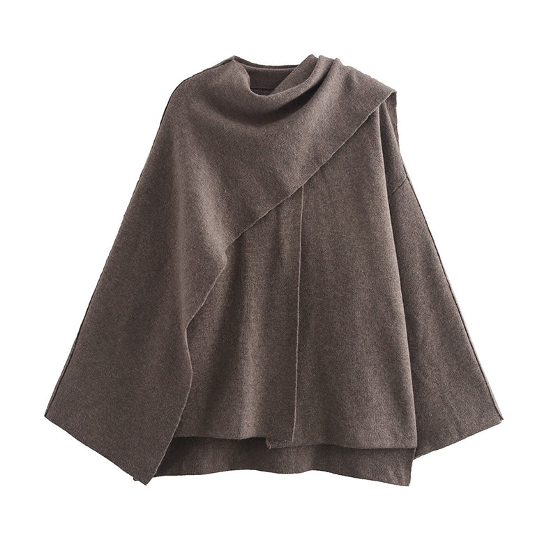 Woman wearing knit cardigan coat with asymmetric scarf detail