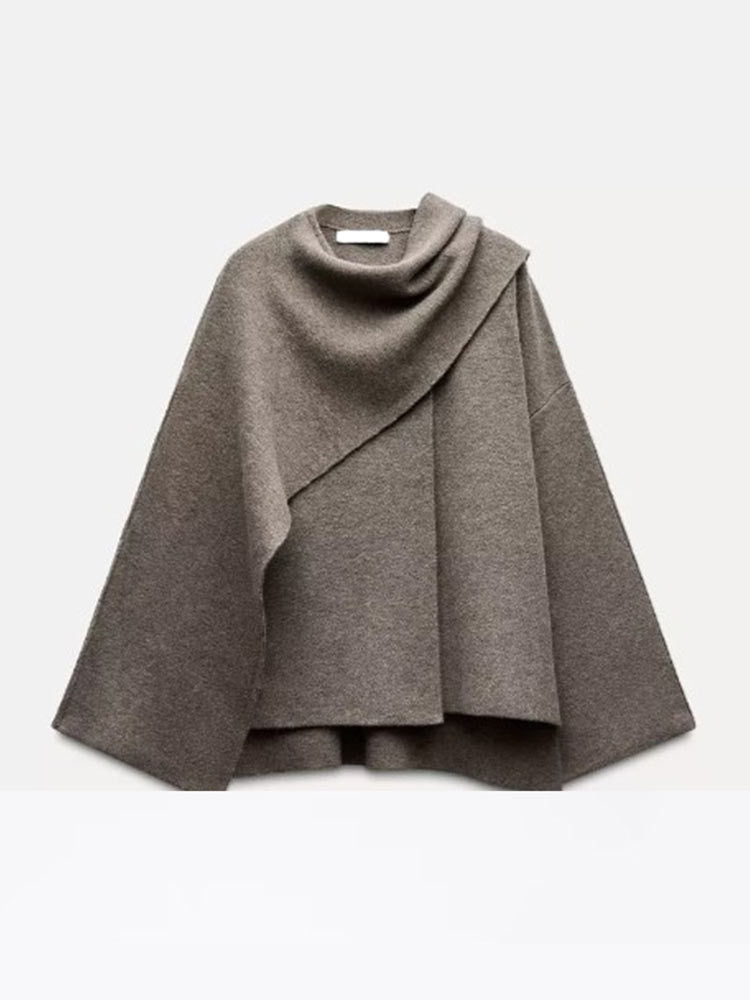 Woman wearing knit cardigan coat with asymmetric scarf detail