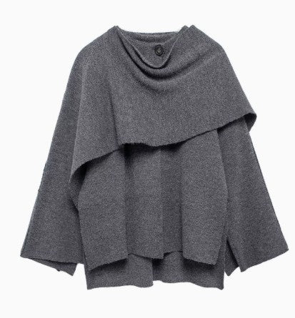 Woman wearing knit cardigan coat with asymmetric scarf detail