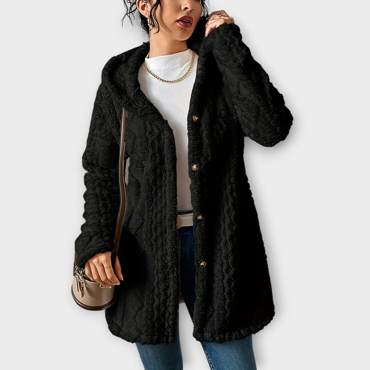 Woman wearing textured hooded winter jacket in relaxed fit