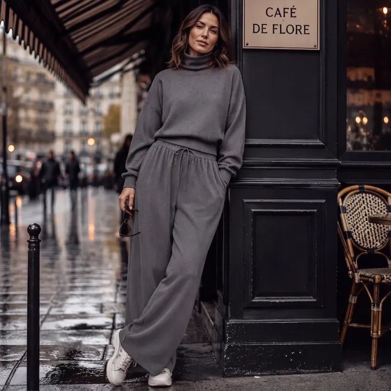 Woman wearing black turtleneck two-piece set with wide-leg trousers