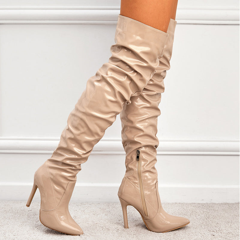 Woman wearing black knee high pointed toe heel boots