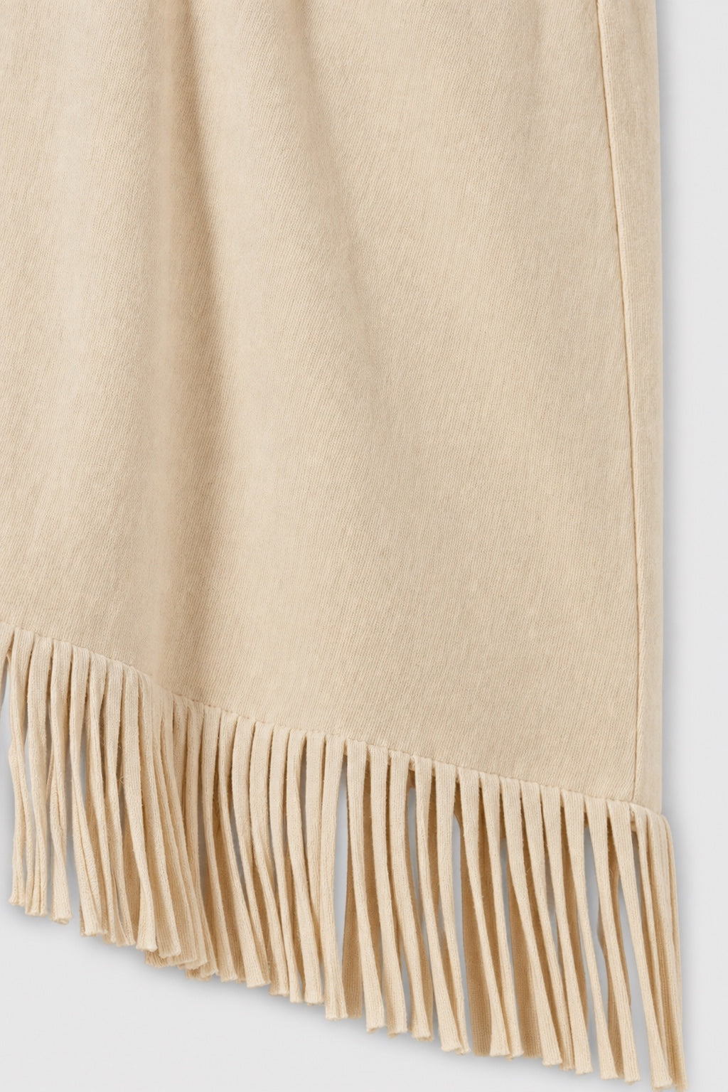 Brianna Boho Fringe Dress in beige – close-up of the fringe hem and soft fabric