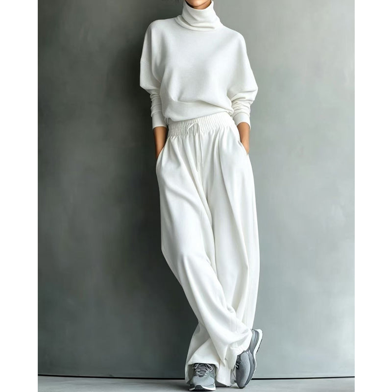 Woman wearing black turtleneck two-piece set with wide-leg trousers