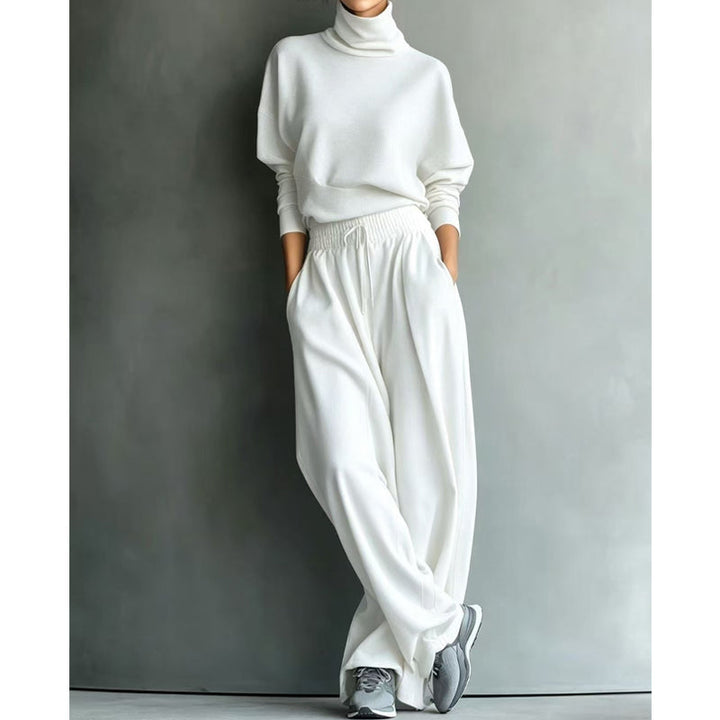 Woman wearing black turtleneck two-piece set with wide-leg trousers