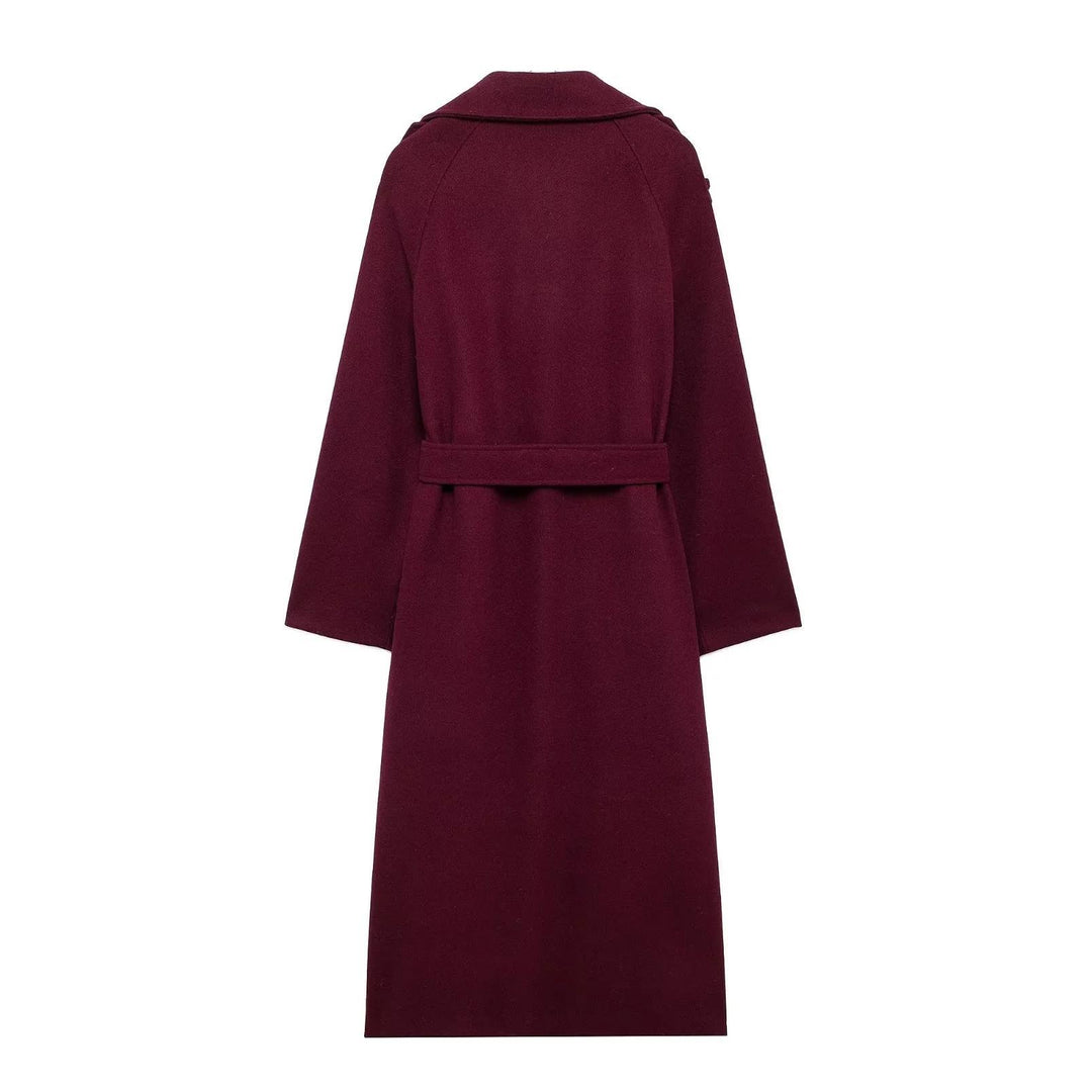 Woman wearing wine red long double-breasted trench coat with belt